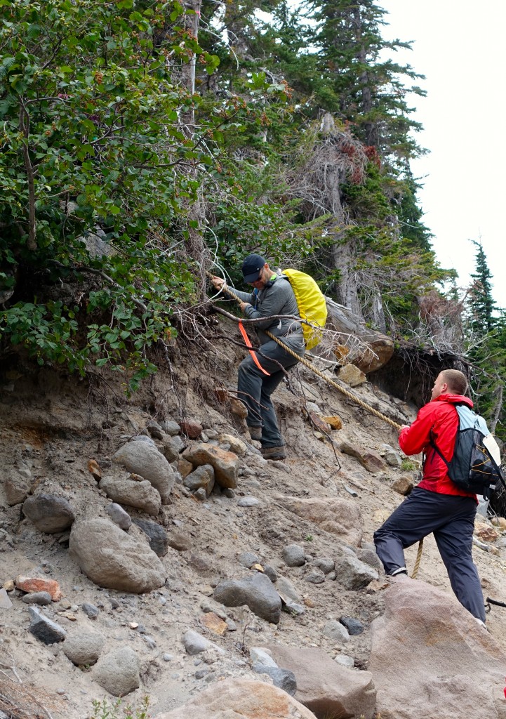 Glenn repelling down a steep embankment at the bottom of a canyon near one of the many stream crossings