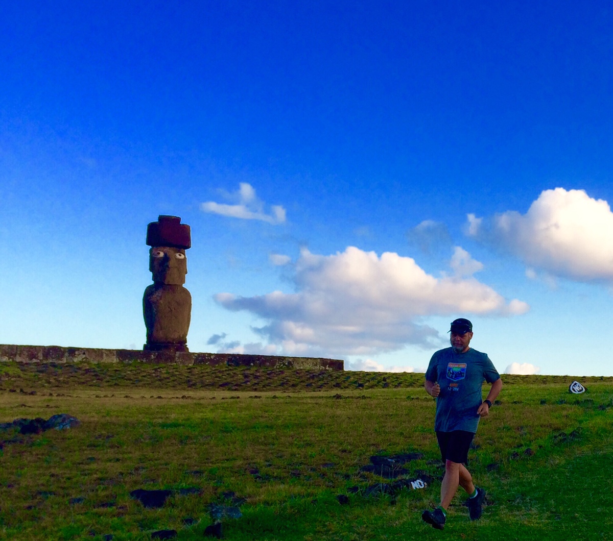 Glenn out for an early morning jog past one of the restored moai with eyes and a top-knot of hair of red stone.