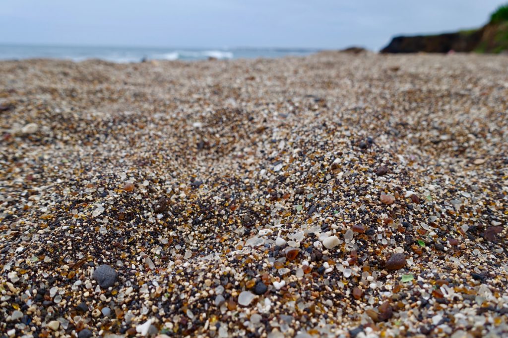Glass Beach - there are tiny pieces of clear, green and brown polished glass.