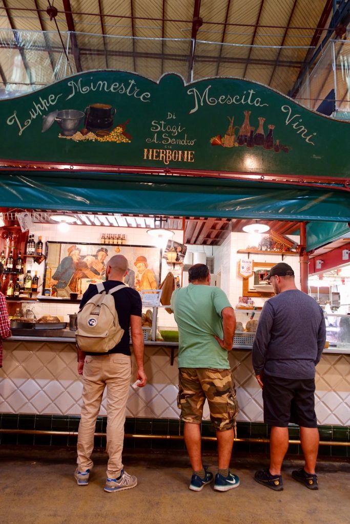 Glenn standing in line to get one of the Florence central market's famous tripe sandwiches.