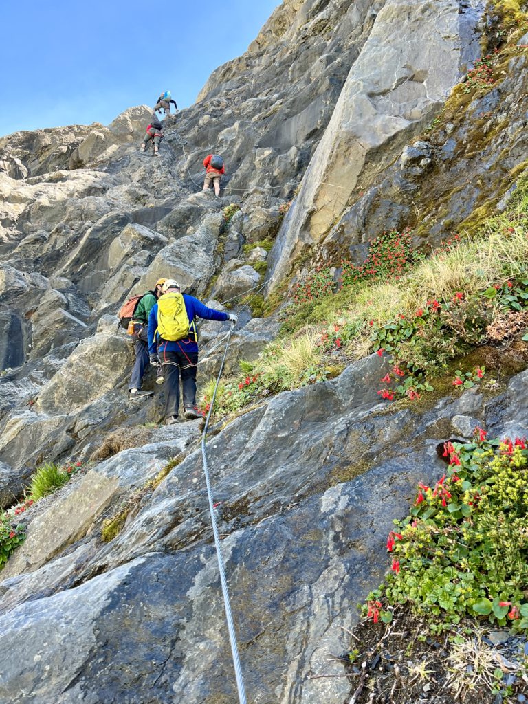Glenn (green pack) about halfway up one of several rock faces in this section of the trail.
