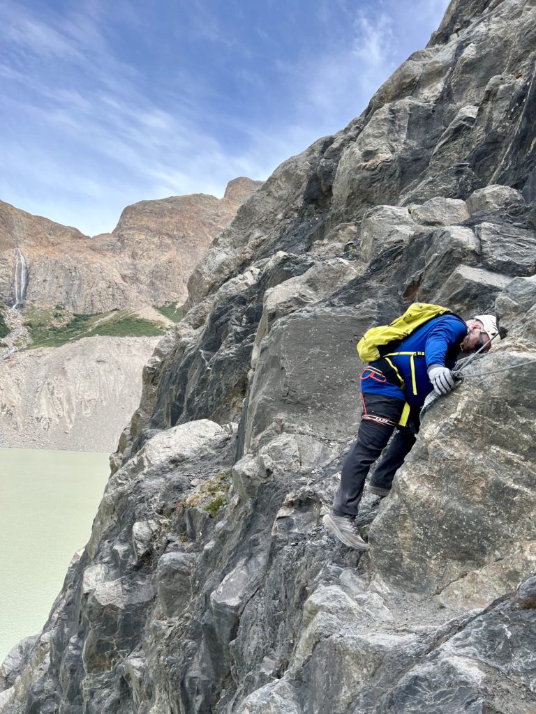 Glenn scaling large walls of rock via ferrata to reach the glacier.